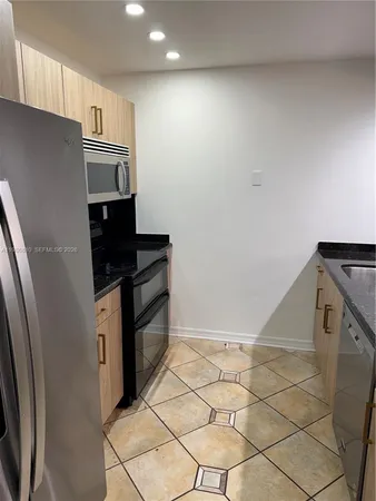 a kitchen with stainless steel appliances cabinets and a counter top space