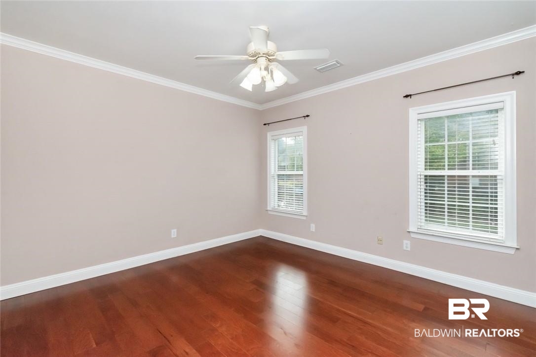 8837 Dawes Lake Road South Mobile, AL 36619 - Photo 27 of 44 Unfurnished room featuring dark wood-type flooring, ceiling fan, and ornamental molding