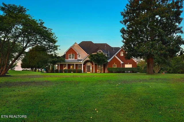 a front view of house with yard and green space