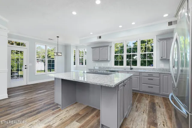 a view of a room with wooden floor and white walls