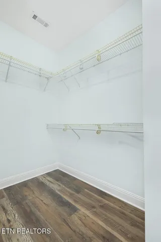 a view of an empty room and wooden floor