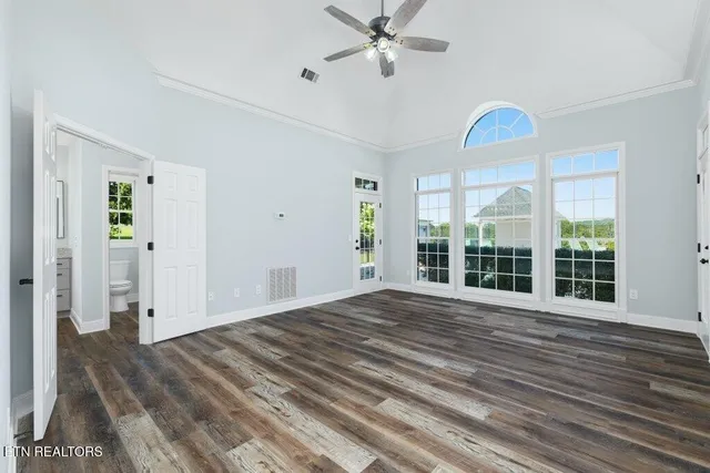 a view of a room with wooden floor and white walls