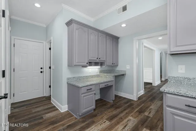 a bathroom with a granite countertop toilet sink and mirror