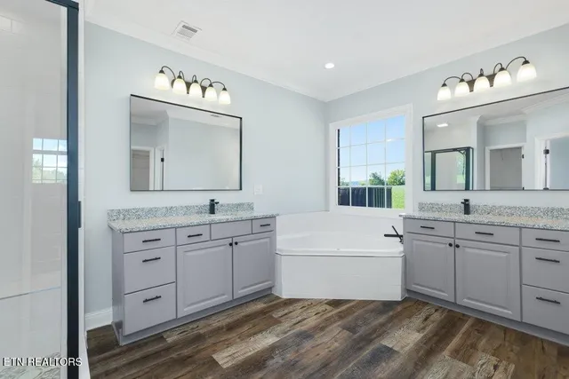 a bathroom with a granite countertop toilet sink and mirror