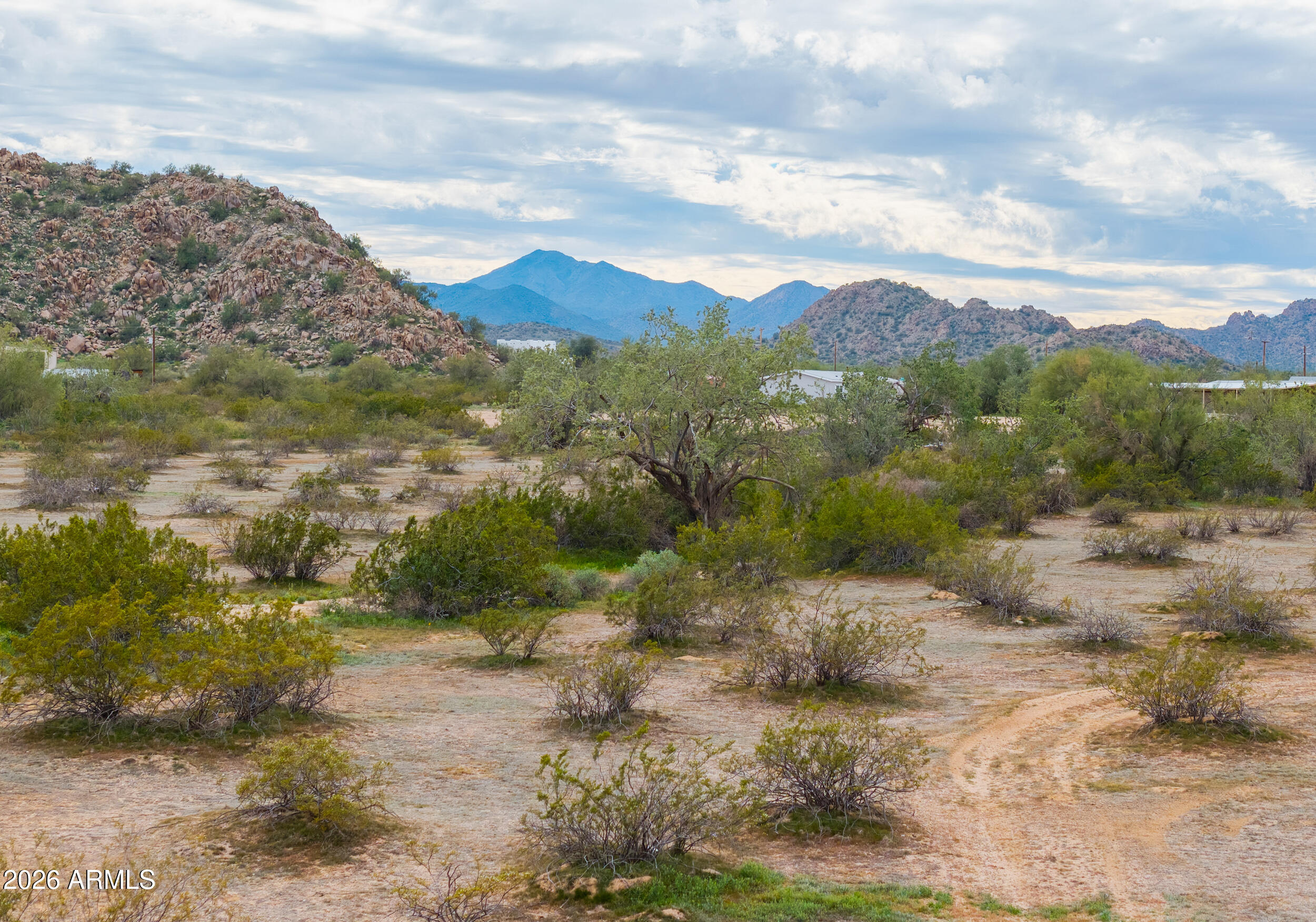 0 West Dune Shadow Road, Unit 42 Maricopa, AZ 85139 - Photo 5 of 25 a view of a yard with mountains in the background