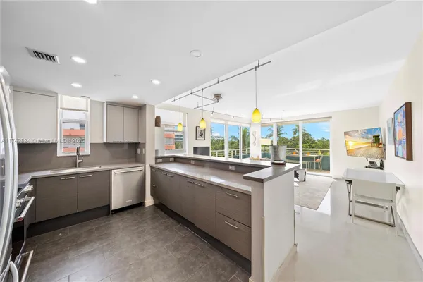 a large white kitchen with a large window