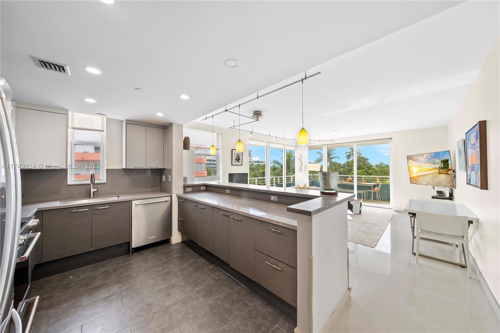 a large white kitchen with a large window