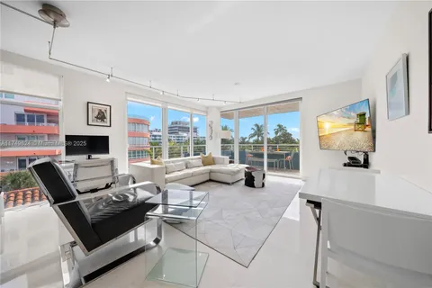 a living room with furniture large window and flat screen tv