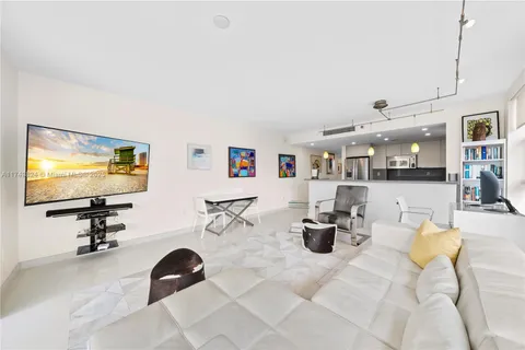 a view of a livingroom with furniture and a flat screen tv