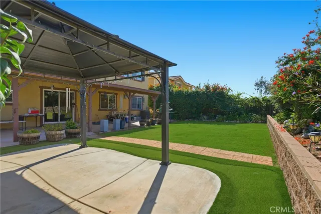 a view of a patio with a table and chairs under an umbrella