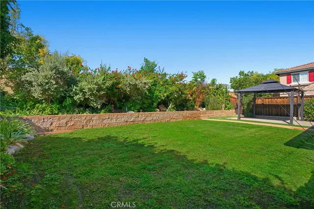 a view of green field with house in the background