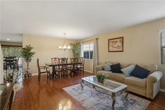 a living room with furniture dining table and a potted plant