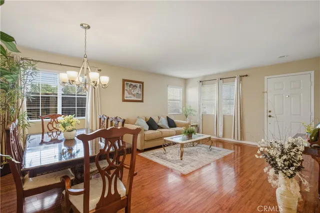 a living room with furniture a window and a chandelier