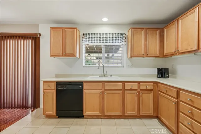 a kitchen with white cabinets and sink