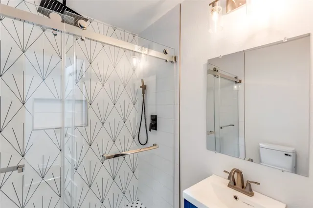 a bathroom with a sink toilet and shower