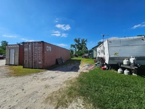 a view of a backyard with plants and brick wall