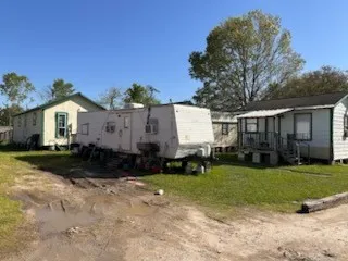 a view of a house with backyard and sitting area