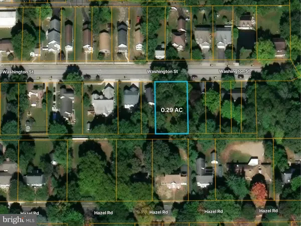 an aerial view of a residential houses with outdoor space and street view