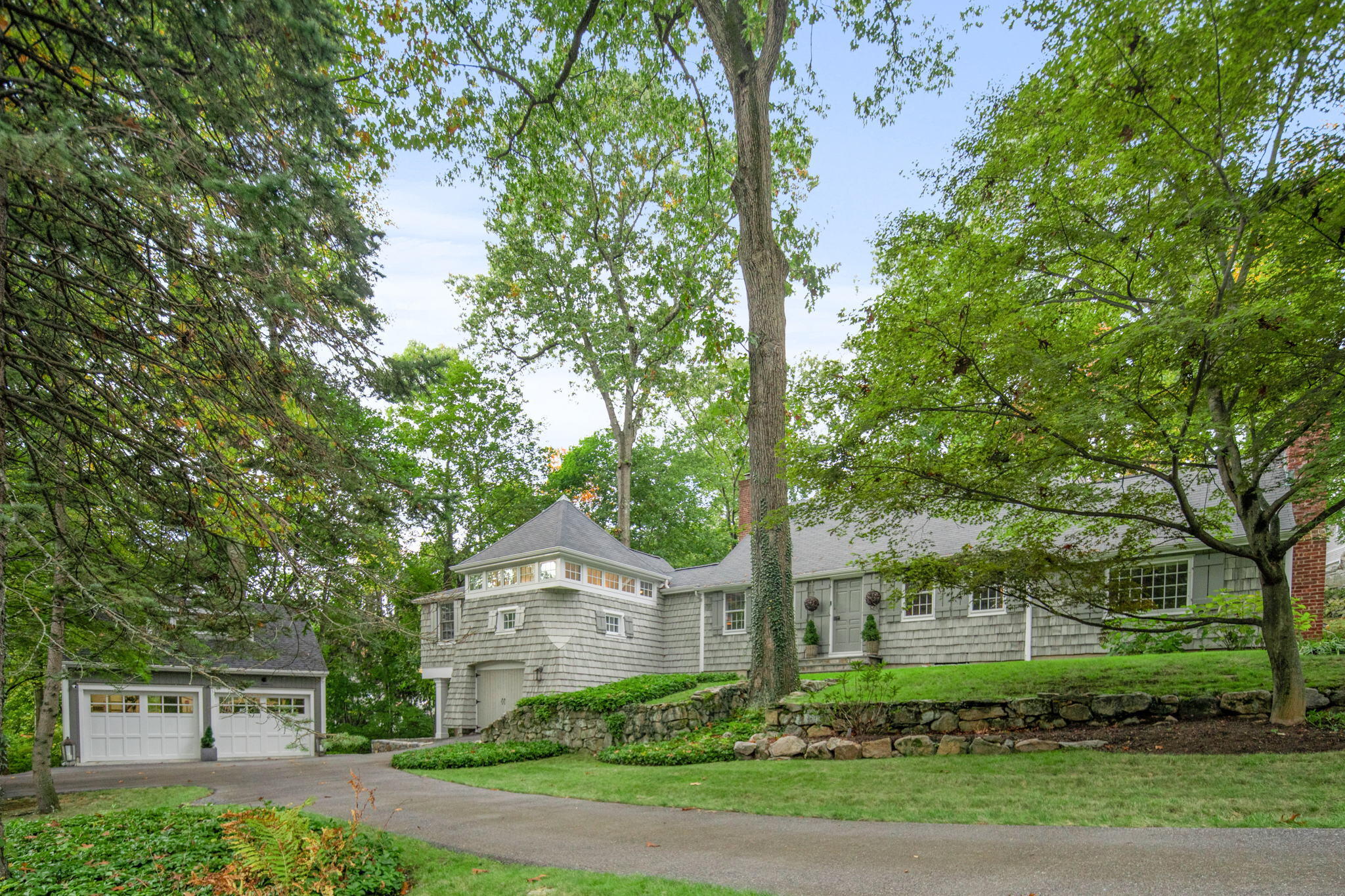 7 Little Brook Road Rowayton, CT 06853 - Photo 2 of 36 a front view of a house with a yard and trees
