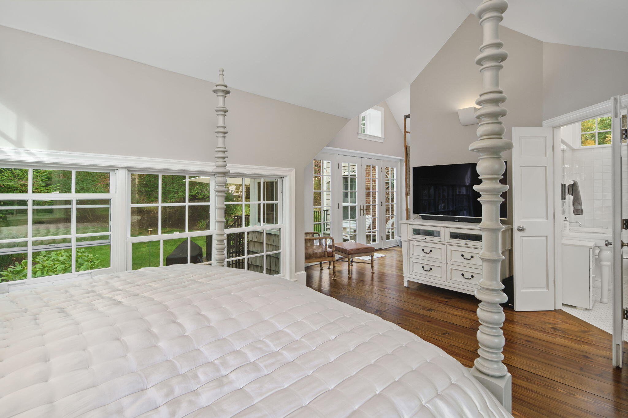 7 Little Brook Road Rowayton, CT 06853 - Photo 15 of 36 a large white bed in a large room with a flat tv screen and a dresser