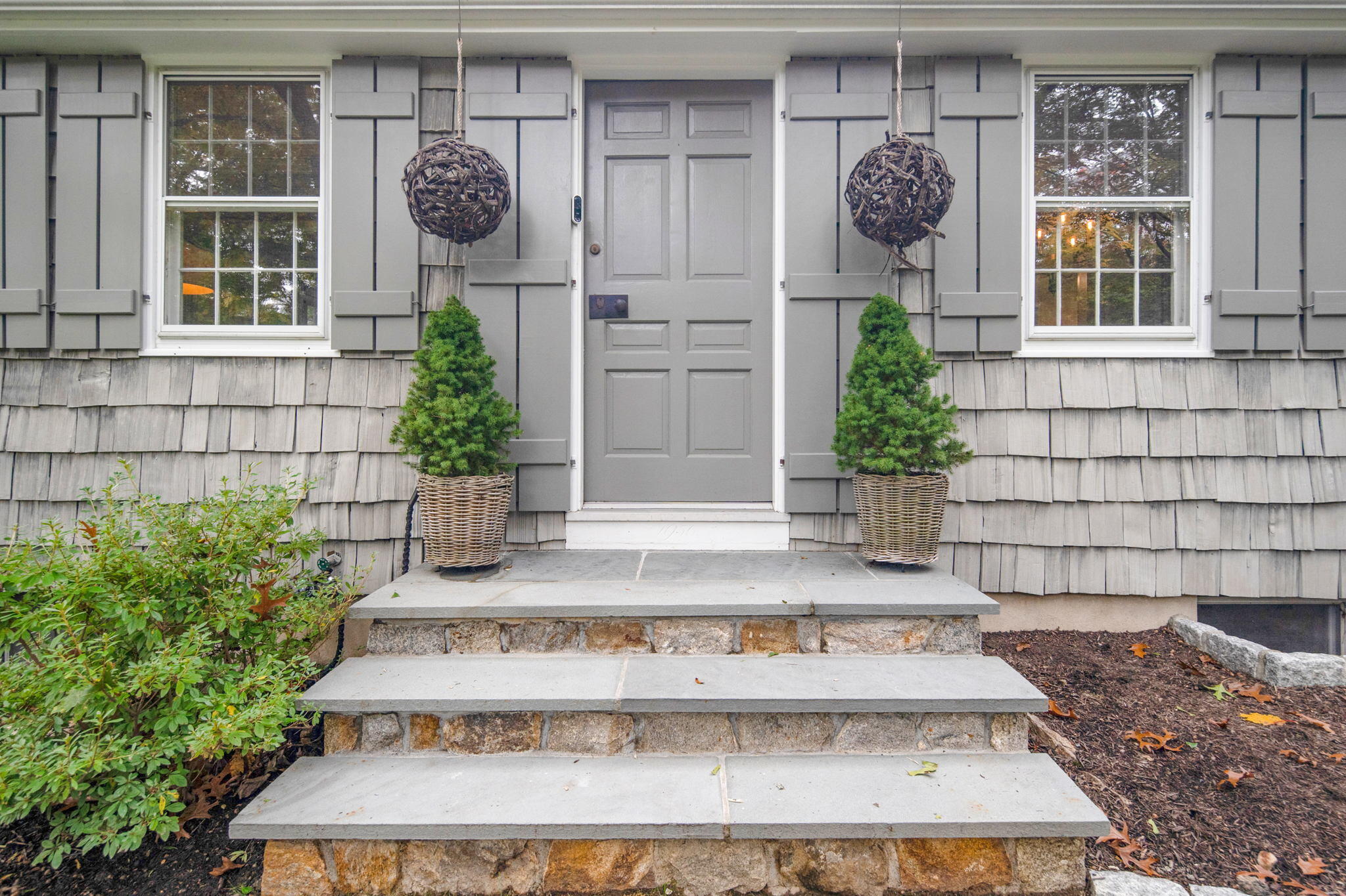 7 Little Brook Road Rowayton, CT 06853 - Photo 3 of 36 a view of a brick house with potted plants and a potted plant