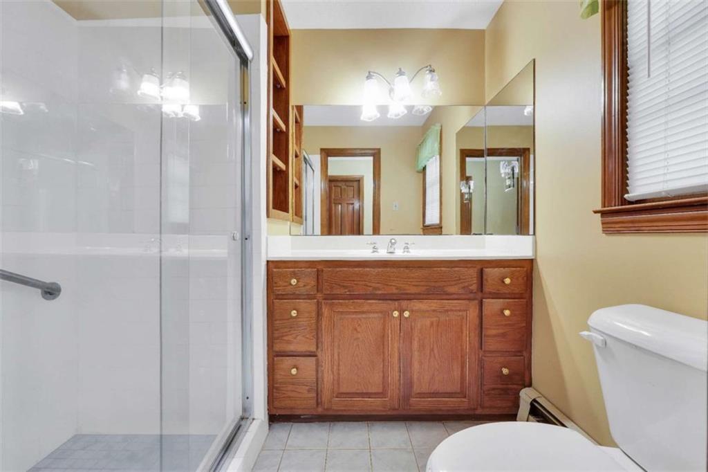 314 Winding Stream Trail Southwest Conyers, GA 30094 - Photo 29 of 59 a bathroom with a toilet a sink and mirror
