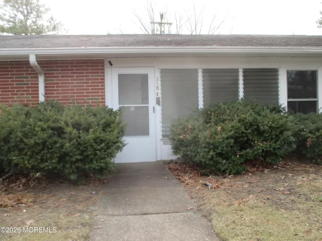a front view of a house with plants