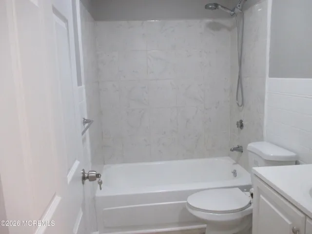 a bathroom with a toilet and a bath tub