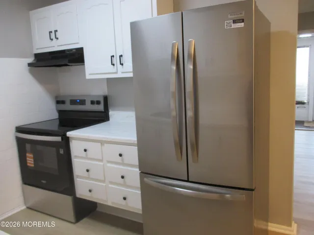 a kitchen with cabinets and stainless steel appliances