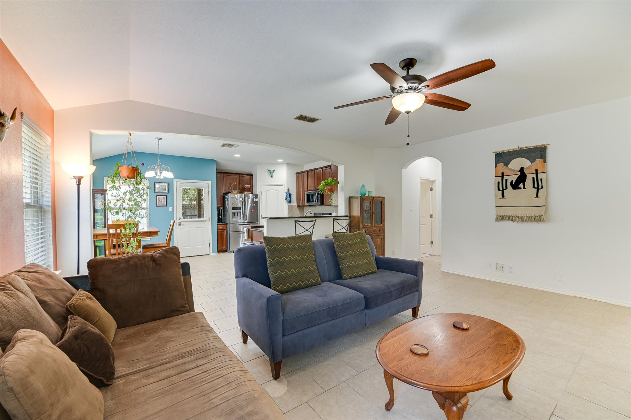 536 Dragon Ridge Road Buda, TX 78610 - Photo 5 of 20 Living area featuring vaulted ceilings, light tile flooring, and an arched doorway