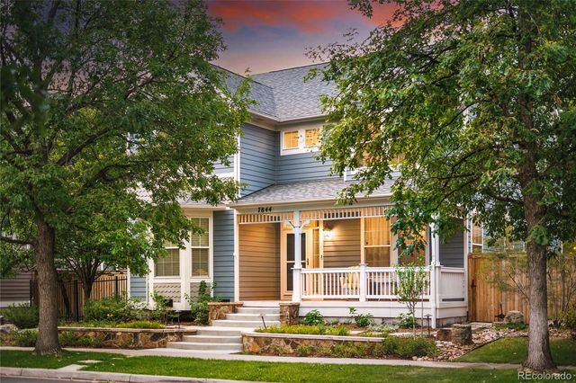 front view of a house with a tree