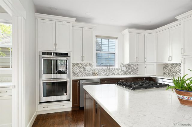 a kitchen with a stove and white cabinets
