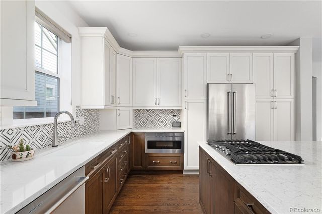 a kitchen with kitchen island a sink stove and refrigerator