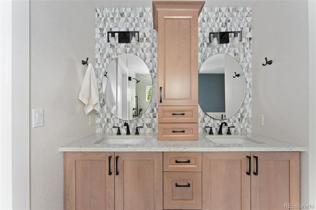 a bathroom with double vanity sink and mirror