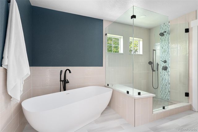 a bathroom with a bathtub and shower