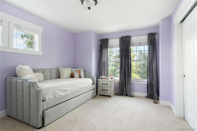 a bed room with a bed and a window