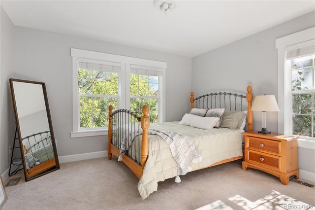 a bed room with a bed and a window