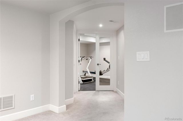 a view of a hallway with furniture