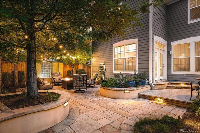 a living room with patio furniture and a potted plant