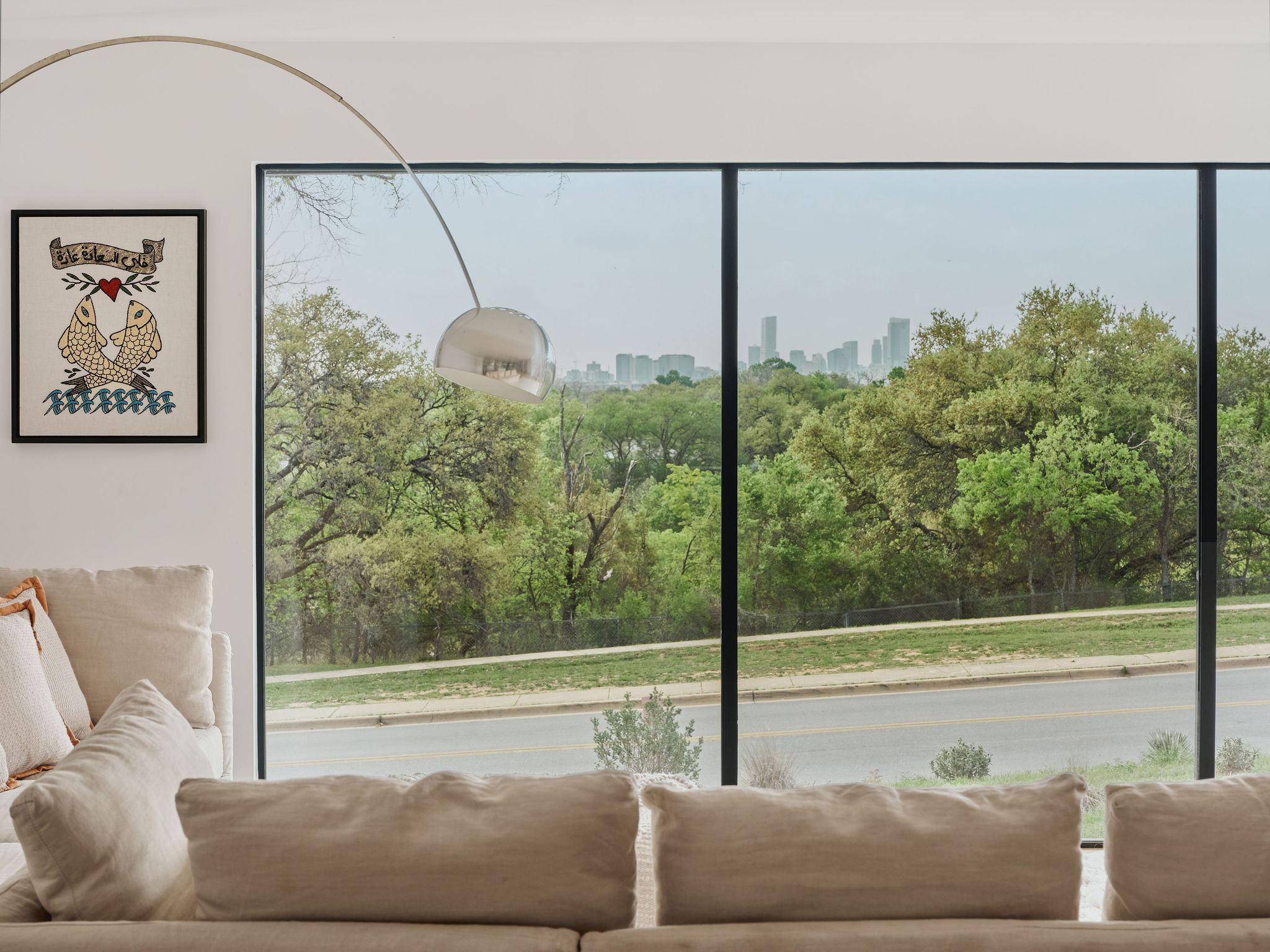 Undisclosed Address Austin, TX 78731 - Photo 4 of 26 Floor-to-ceiling windows frame verdant trees and the city skyline.
