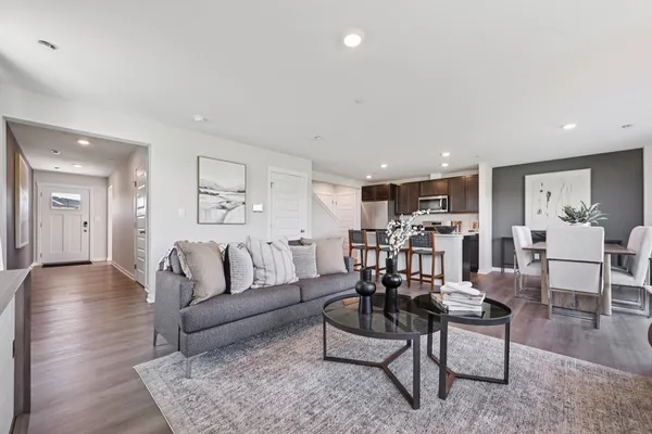 a living room with furniture and wooden floor