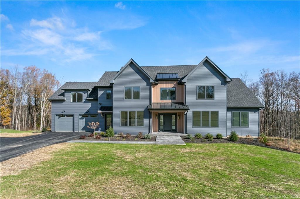 a front view of a house with a yard table and chairs
