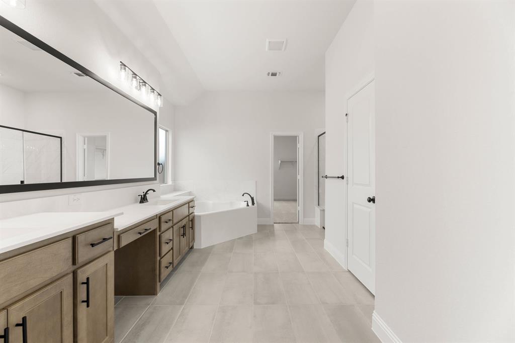 733 Wine Cup Way Midlothian, TX 76065 - Photo 15 of 30 a large bathroom with a double vanity sink a large mirror and a shower