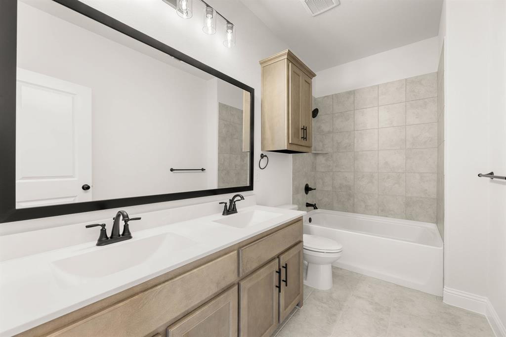 733 Wine Cup Way Midlothian, TX 76065 - Photo 19 of 30 a bathroom with a sink a toilet and a bathtub
