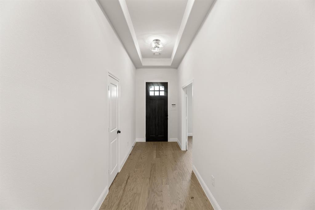 733 Wine Cup Way Midlothian, TX 76065 - Photo 21 of 30 a view of a hallway with wooden floor and a bathroom