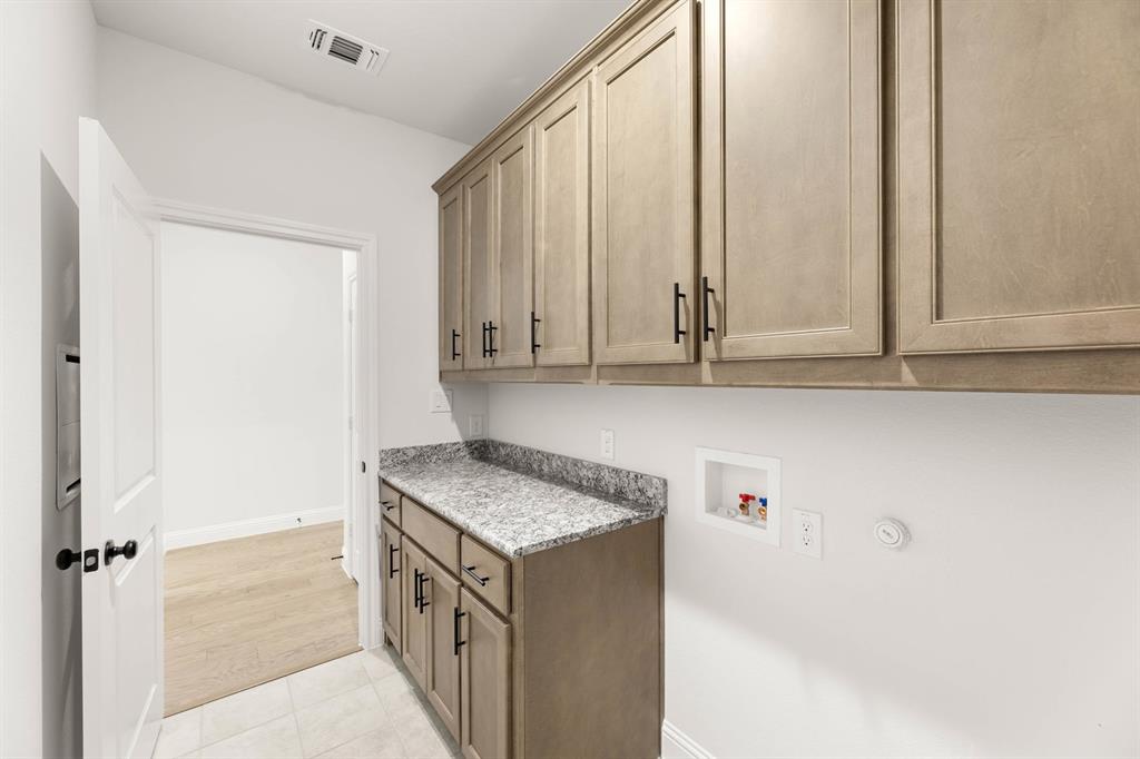 733 Wine Cup Way Midlothian, TX 76065 - Photo 23 of 30 a kitchen with stainless steel appliances granite countertop a sink and dishwasher with white cabinets