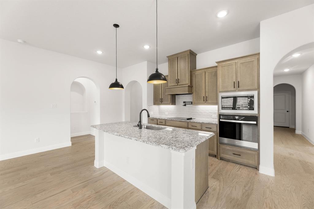 733 Wine Cup Way Midlothian, TX 76065 - Photo 3 of 30 a kitchen with stainless steel appliances granite countertop a sink a stove and a refrigerator