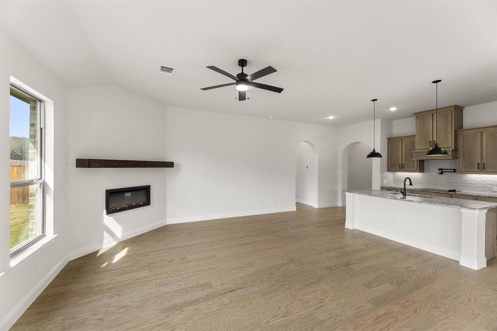 733 Wine Cup Way Midlothian, TX 76065 - Photo 6 of 30 a view of a kitchen with a sink and a fireplace