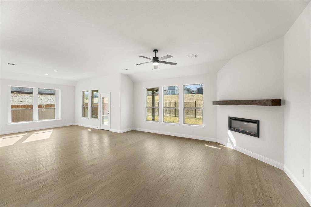 733 Wine Cup Way Midlothian, TX 76065 - Photo 7 of 30 a view of an empty room with a window and wooden floor