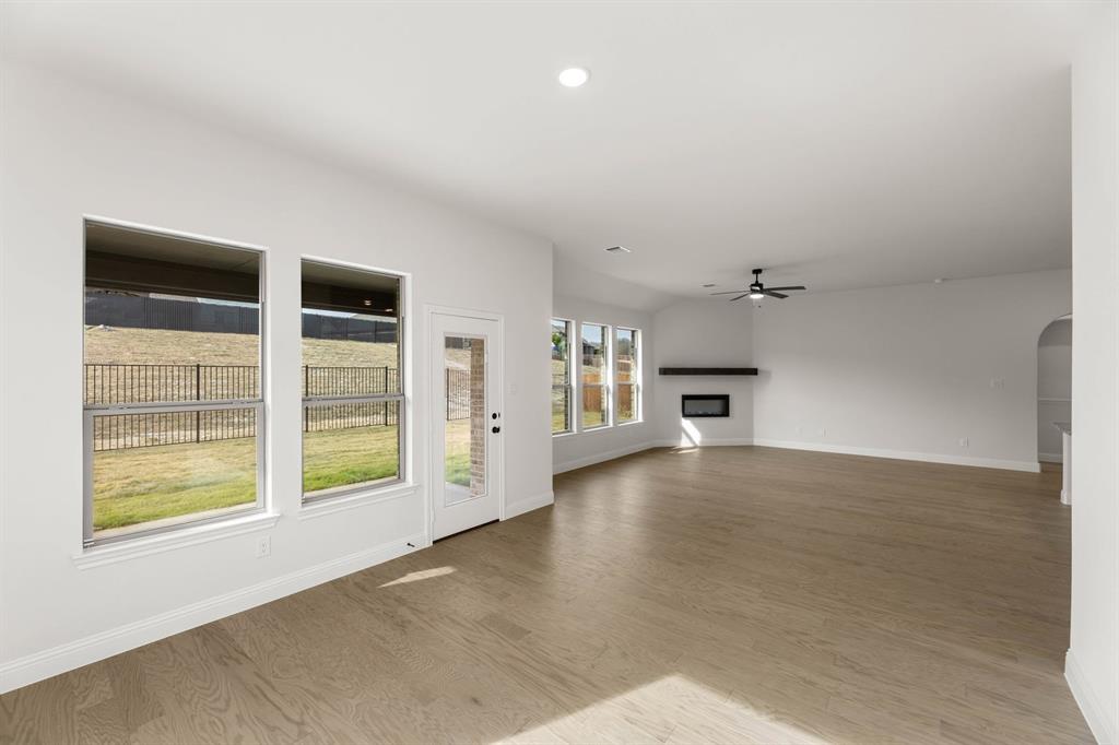733 Wine Cup Way Midlothian, TX 76065 - Photo 9 of 30 an empty room with windows and fireplace